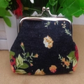 Close-up of vintage black floral canvas coin purse with silver metal kiss-lock closure - Black