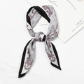 Gray silk-like scarf with pink chain patterns and black edges in a knotted display - Chain Grid Light Gray