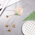 Hollow wooden Christmas tree ornament with green bow and copper bells on grey surface - Double Round Bell Wooden Pendant
