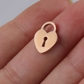 Mini rose gold stainless steel heart lock pendant shown on fingertip for size reference - Lock / Rose Gold