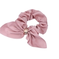 Pink satin rabbit ear hair tie with golden metal ring detail on a white background - Pink