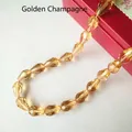 Close-up of faceted teardrop glass beads in gold champagne for DIY jewelry making - 4*6mm / Gold Champagne