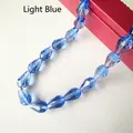 Macro shot of light blue faceted crystal glass teardrop beads for DIY jewelry making - 3*5mm / Light Blue