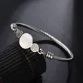 Detail view of Saint Benedict silver stainless steel cable bracelet with three religious medals - Steel