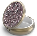 Detailed macro view of portable round pill case with sparkling pink rhinestones and dividers - Bronze - Light Purple Rhinestone