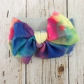 DIY baby headband with colorful tie-dye bow on a rustic wooden background - AB Color