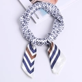 Silk satin square scarf featuring navy and caramel chain patterns on white base - Horsebit Chain Blue-White
