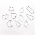 Detailed view of silver geometric open bezels including star, heart and moon shapes - Mixed 10PCS White K Silver