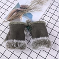 Detailed view of olive green fingerless gloves with faux fur trim and lace-up design - One Size / Army Green