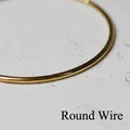 Macro detail of polished 18K gold-plated titanium steel round wire minimalist bracelet - Round Wire Large