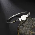 Detail view of silver stainless steel twisted cable bracelet with three heart charms - Steel