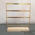 Gold 69-hole metal earring display rack with natural wood base for jewelry storage - 31*27cm / Gold