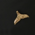 Detailed view of an 18K gold-plated stainless steel mermaid tail pendant with embossed texture - Gold Whale Tail