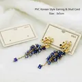 Detail of floral grape-shaped drop earrings with gradient beads on a white PVC display card - EA-PVC016 3x5cm Beige Eco-Paper