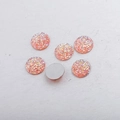 Macro detail of 14mm round flatback resin cabochons with sparkling orange glitter texture - 14mm / Peach Gold