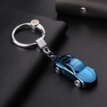 Blue car-shaped metal keychain with LED light and polished finish on black leather background - Blue Ice