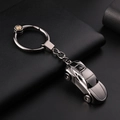 Gunmetal grey car model keychain with metallic finish on black textured leather surface - Black Ice