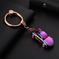 Rainbow car keychain with rose gold hardware on dark leather background featuring LED light - Iridescent