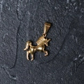 Minimalist gold-plated stainless steel unicorn pendant on a textured dark stone background - H10 Unicorn