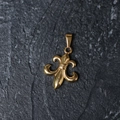 Golden fleur-de-lis pendant in titanium steel on a dark stone texture background - H09 Fleur-de-lis