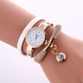Close-up of a white wrap-around watch with a gold rhinestone bracelet on a wrist - White