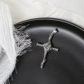 Detailed macro view of silver cross pendant with embossed rose and vine design - Silver Rose Cross