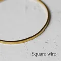 Detailed close-up showing the square wire design and golden finish of the thin bracelet - Square Wire Large