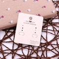 Beige jewelry display card with crown logo for earrings on a woven texture background - Beige Eco-Paper No.5 5x6cm