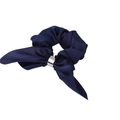 Close-up of a navy blue satin bow scrunchie featuring an elegant gold metal ring detail - Blue