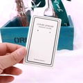 Close-up of white jewelry display card featuring elegant Luxury Jewelry lettering - EA-ZK028 5x8.3cm New LJ Border