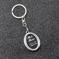 Close-up of silver metal photo frame keychain showing precise 2.65cm x 3.9cm dimensions - Oval Photo Frame