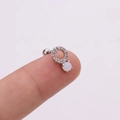 Macro shot of silver screw back earring with clear zircons and white opal stone - Round Opal Inlaid / Silver