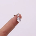 Detail view of silver screw ear stud featuring two clear cubic zirconia stones on hand - Vertical Double Round Diamonds (Silver 8#)