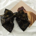 Detail of a large satin leopard print bow hair clip with elegant silk sheen texture - Green Leopard