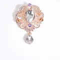 Baroque rose gold brooch with teardrop crystals and purple stones on white backdrop - White