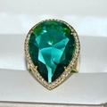 Luxury pear-cut emerald green gemstone ring with diamond halo on gold band in a gift box - Light Green