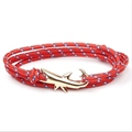 Detailed view of a multi-layer red braided rope bracelet with a golden shark anchor clasp - GSY-06 Red Dotted Rope + Gold Shark Hook