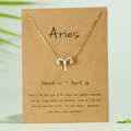 Gold Aries zodiac necklace with rhinestone pendant on brown paper card packaging - Aries / Gold