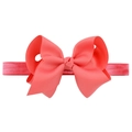 Detailed view of handmade coral pink grosgrain ribbon bow on an elastic baby headband - Coral Pink