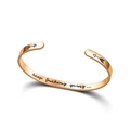 Close-up view showing the 'keep fucking going' message inside a rose gold cuff bracelet - Engraved Version / Rose Gold