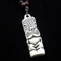 Macro detail of ivory resin Tiki pendant with black engravings and wooden beads - Style A / White