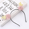 Close-up of a pink reindeer antler headband with gold glitter and Christmas decorations - Pink Pompom Antler Headband
