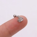 Minimalist silver crown stud earring with clear zircon inlay displayed on a fingertip - Crown Shape / Silver