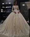 Abito da sposa champagne con scollo a barca, maniche lunghe in pizzo e ricami ricchi - US 2 / Champagne