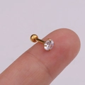 Close-up of golden flower tragus stud with clear zircon stone on a fingertip - Gold Single Zircon Style (金色1#)