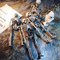 Detailed view of four assorted miniature resin skeletons with realistic weathered texture - 15cm Skeleton