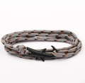 Close-up of gray woven rope bracelet featuring a black shark-shaped metal clasp - Shark Clasp / Gray and Orange