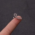 Minimalist silver star cartilage earring with zircons held on a fingertip for scale - Shooting Star Style (7#)