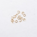 Macro shot of gold-plated stainless steel open jump rings for DIY jewelry making - Gold
