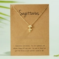 Golden Sagittarius zodiac symbol pendant necklace displayed on a brown kraft card - Sagittarius / Gold